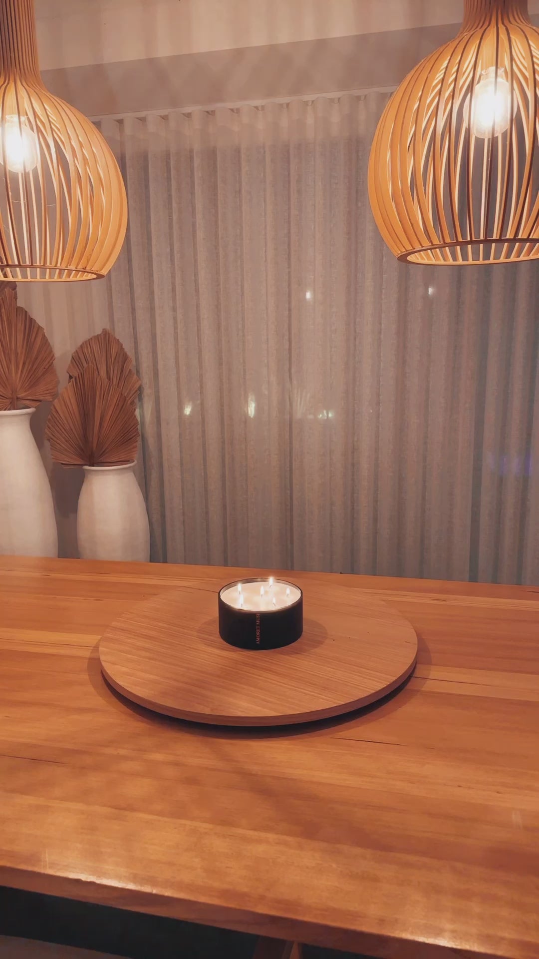 video of black matte centerpiece candles lit in home